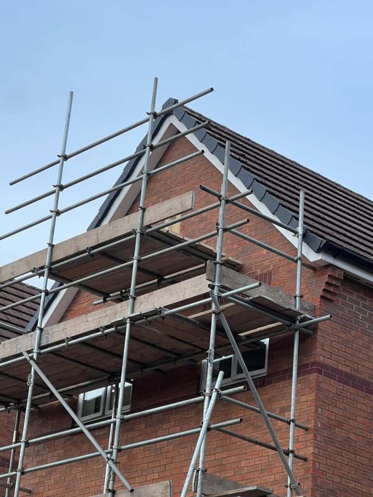 This is a photo of a roof which has just been repaired. There is a scaffold located at the gable end for access onto the roof. Works carried out by Market Harborough Roofing Repairs